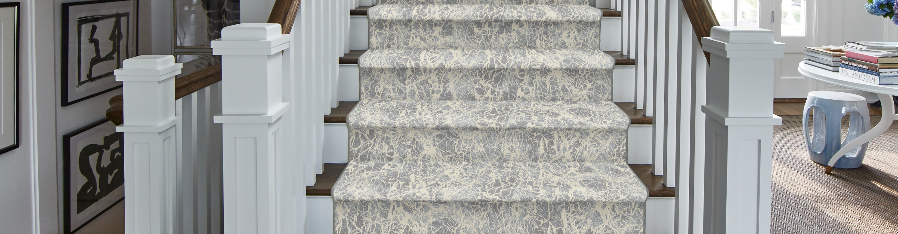 White carpet stair runner with floral pattern. 